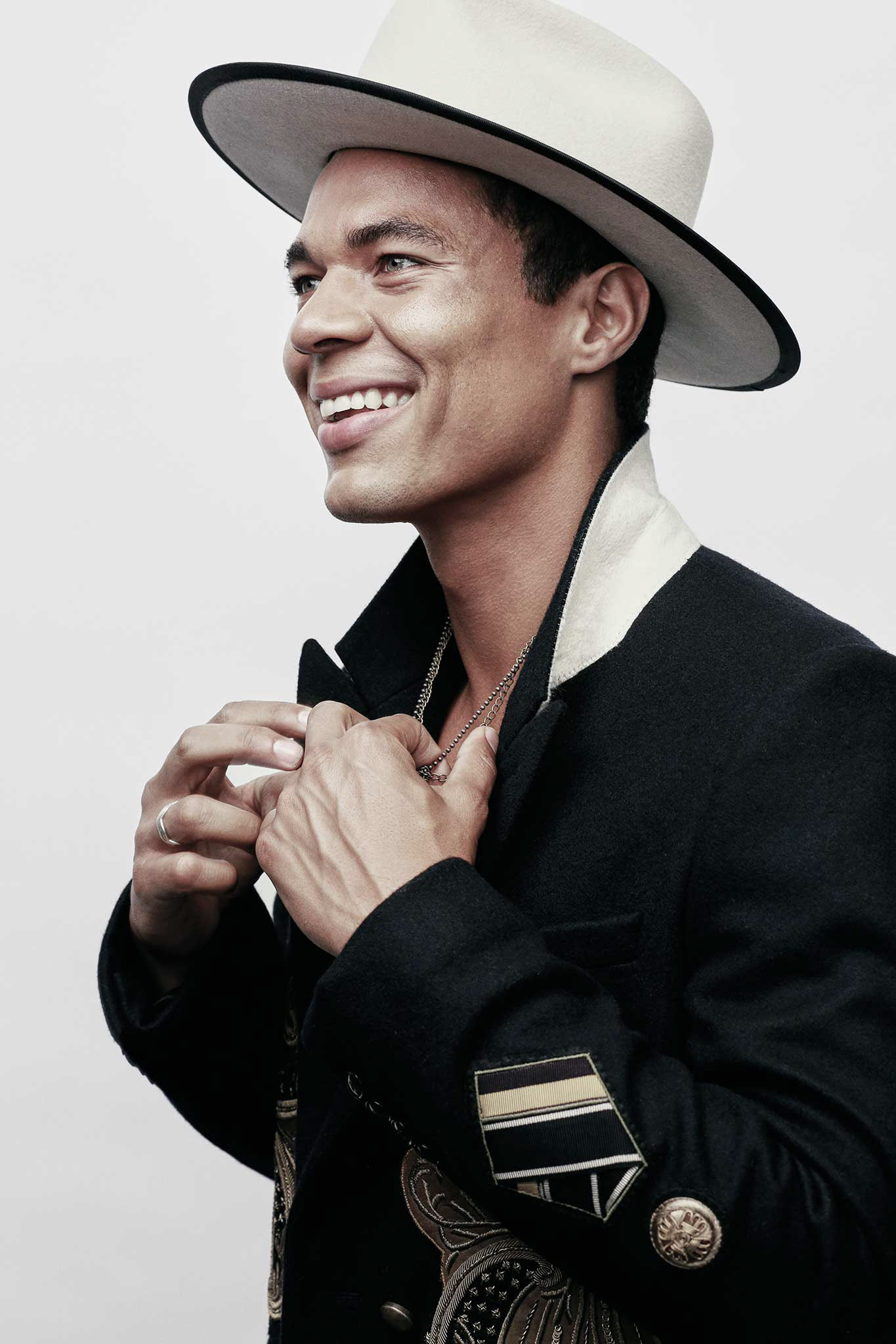 Smiling portrait in a cream hat and embroidered jacket