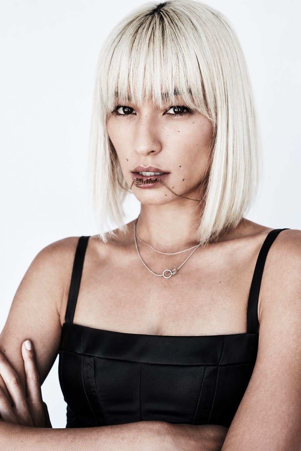 Portrait with a platinum bob and structured black top