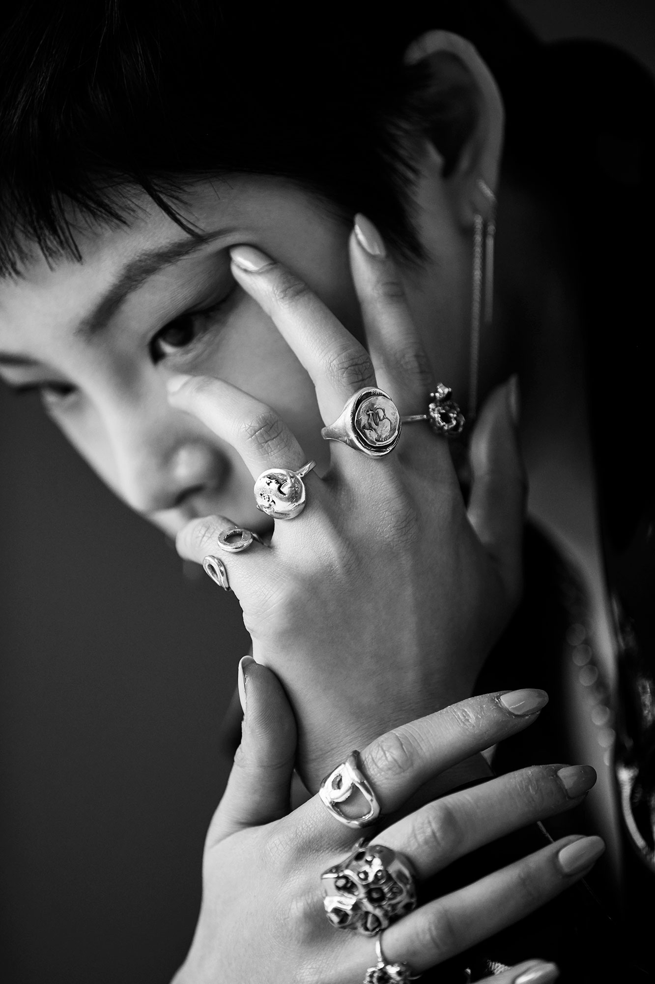 Black and white close-up portrait with silver rings
